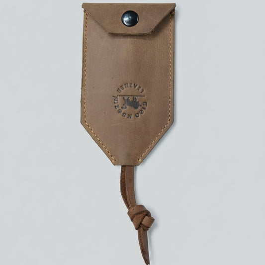 Brown leather pouch with a knot on a wooden surface
