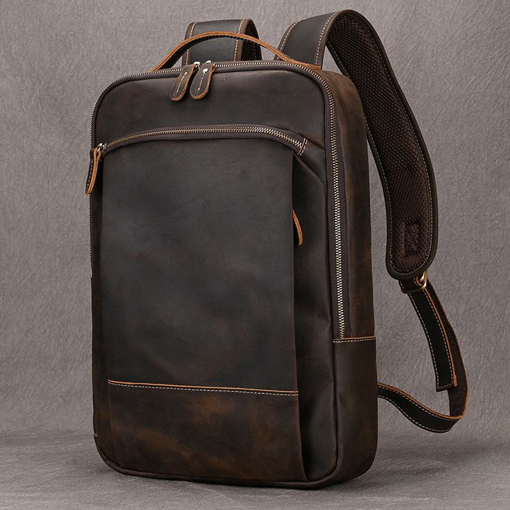 Brown leather backpack on a gray background