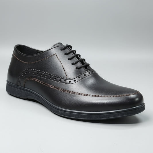 Black leather shoe on a wooden surface with a blurred background