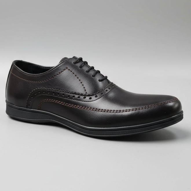 Brown leather shoe on a wooden surface with blurred background