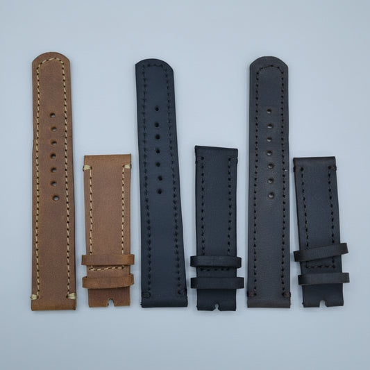Set of leather watch straps on a wooden surface