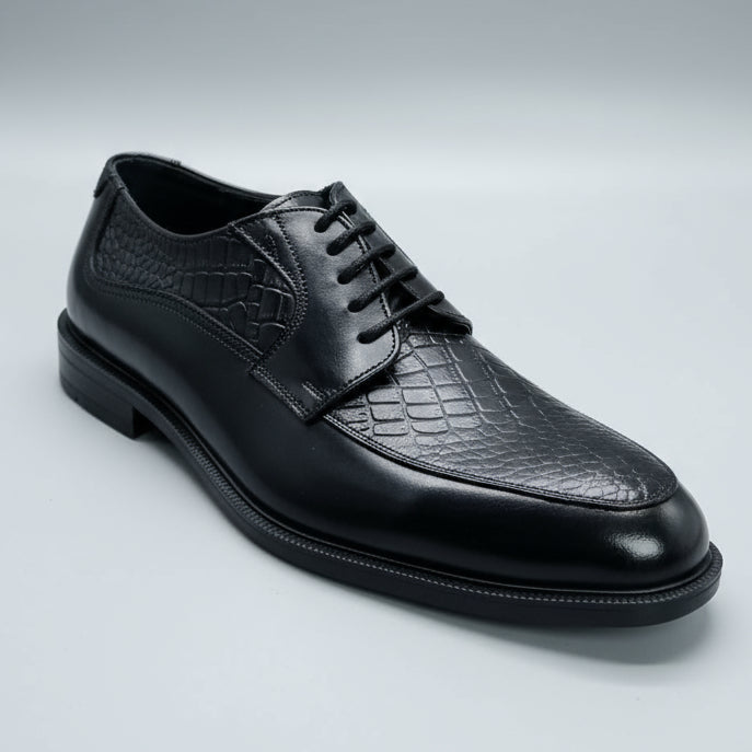 Black leather shoe held in a hand with blurred shoes in the background