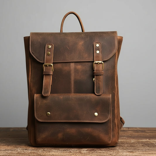Brown leather backpack on a wooden surface with a gray background