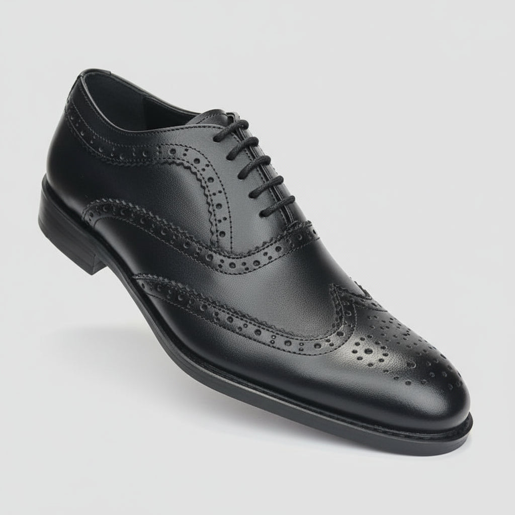 Black dress shoe held in front of a shoe rack with various shoes.