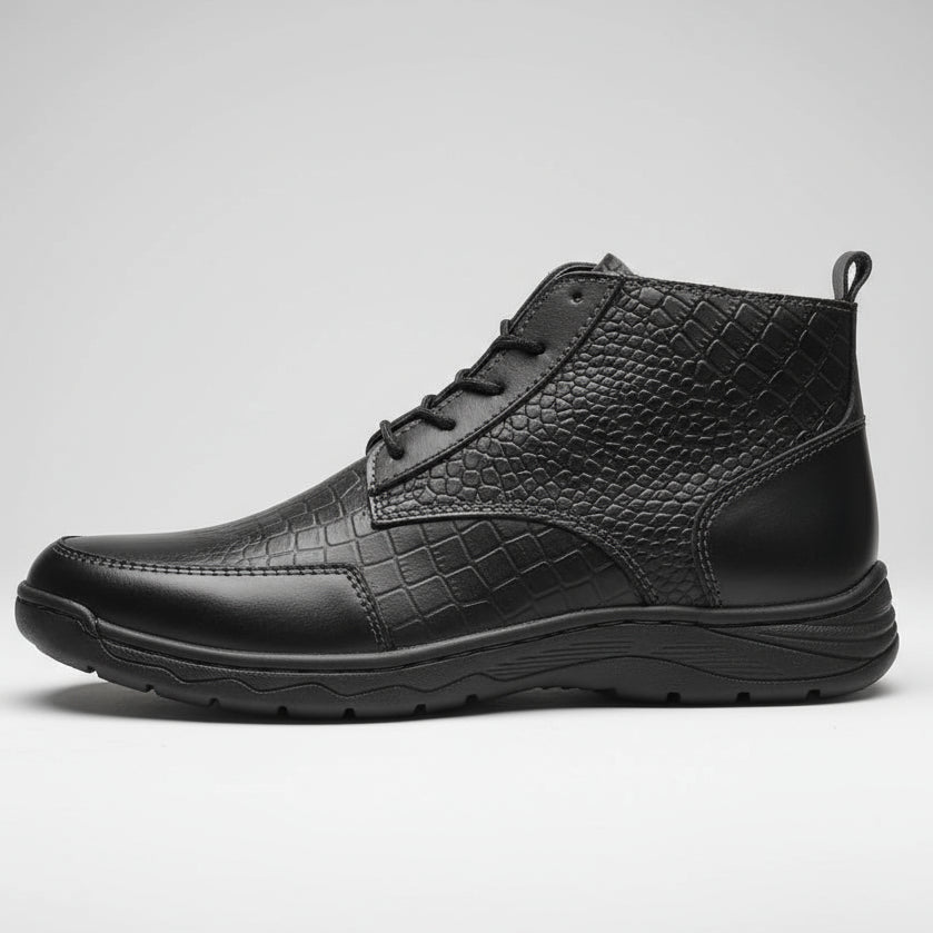 Black leather boot held in a hand with a blurred background