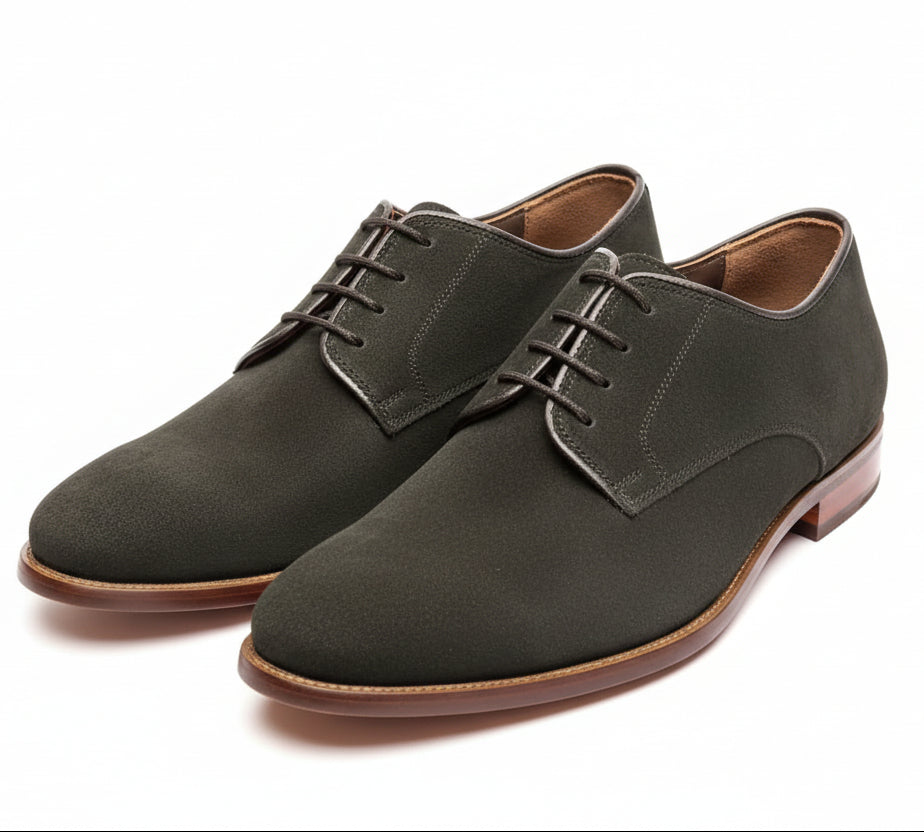 black suede shoes on a wooden surface