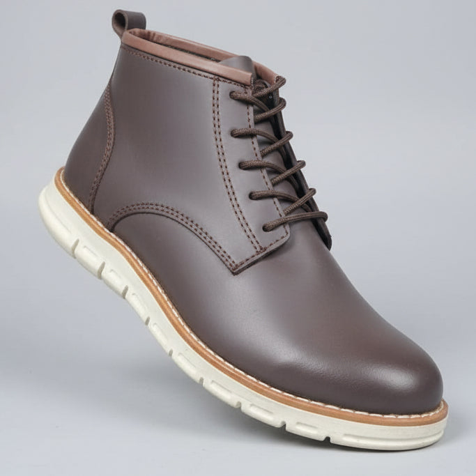 Brown leather boot with white sole on a grid background
