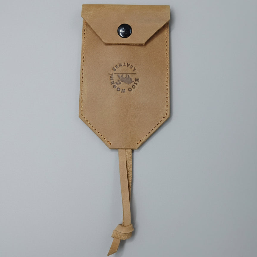 Leather pouch with a brand logo on a wooden surface