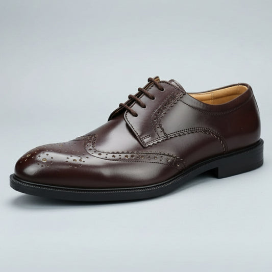 Brown leather shoe held in front of a shoe rack with various shoes.