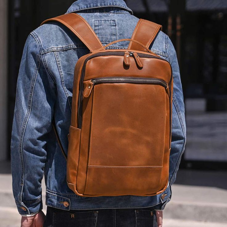 Person wearing a brown leather backpack with a blurred background