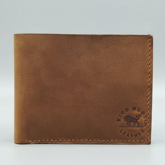 Brown leather wallet with a brand logo on a wooden surface