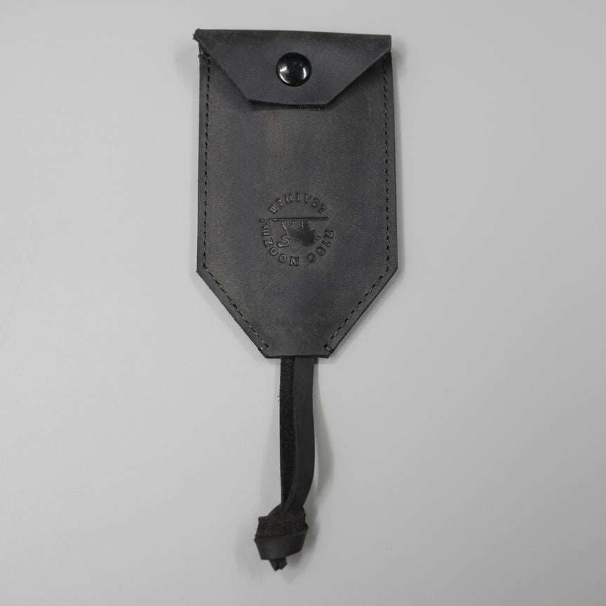 Brown leather pouch with a strap on a wooden surface