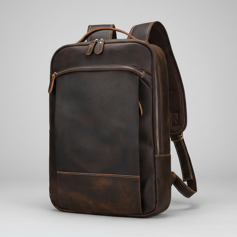 Brown leather backpack on a light gray background