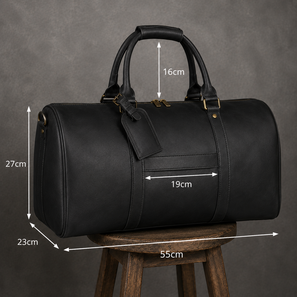 Black leather duffel bag shown on a wooden stool against a gray textured background, with overlaid dimension arrows and labels indicating height, width, and depth measurements.