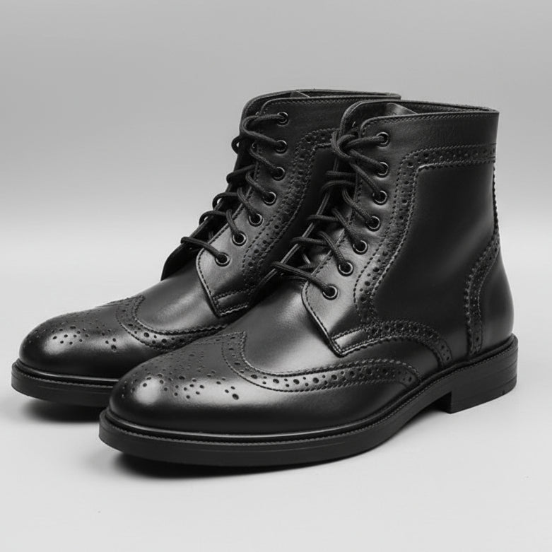 Person holding a pair of black leather boots in front of a shoe rack.