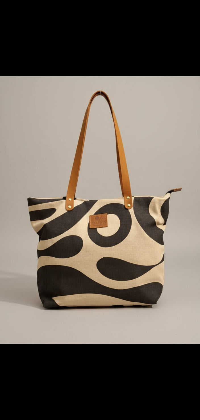 Patterned handbag with gold accents on a chair