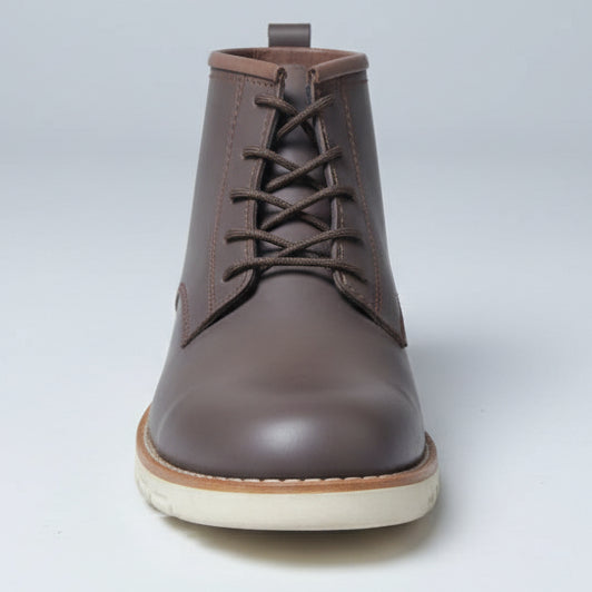 Brown leather boot held in front of a wall of shoes