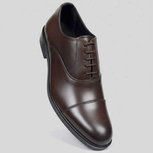 Brown leather dress shoe on a light gray background
